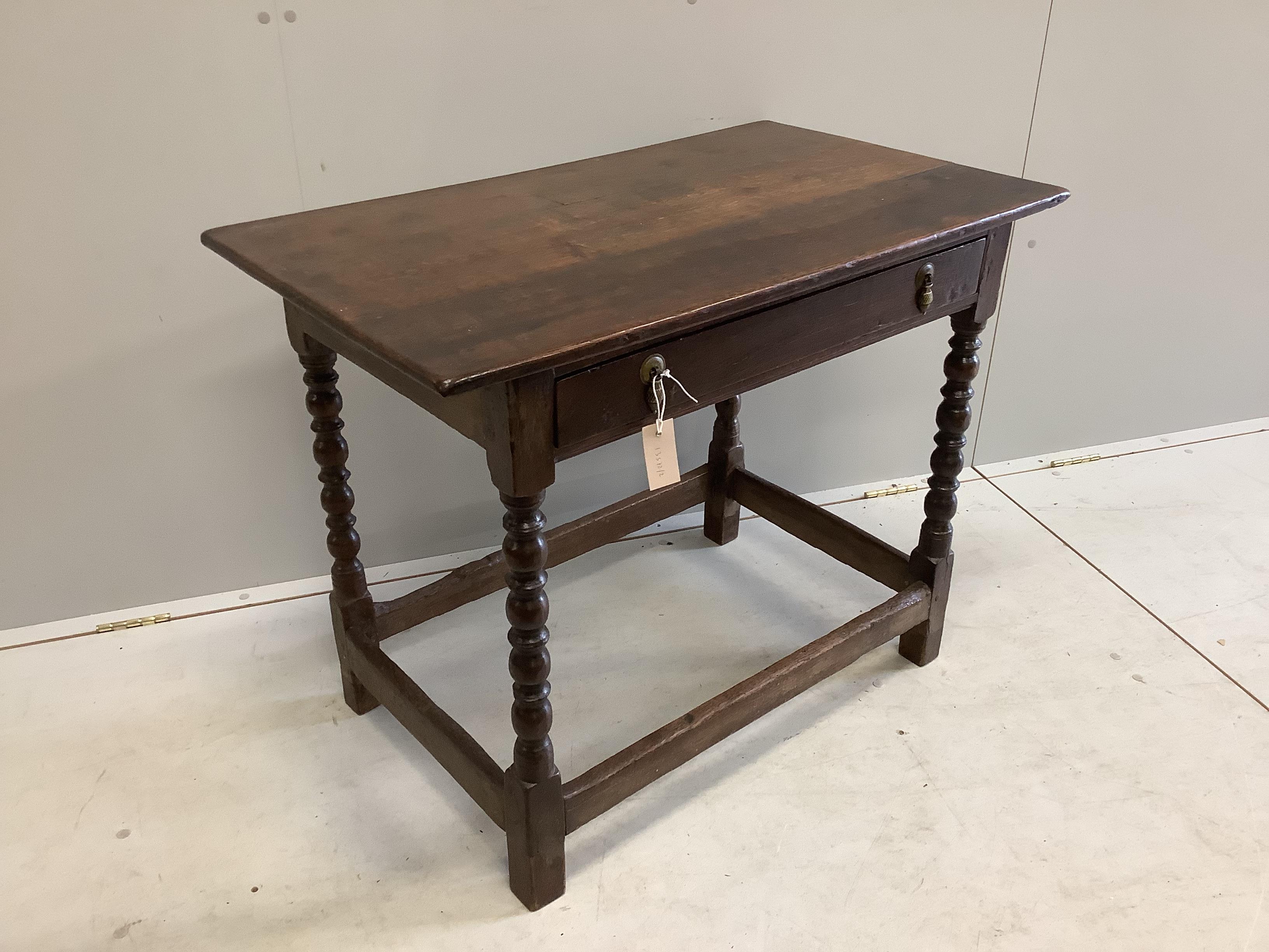 A 17th century Cromwellian rectangular oak single drawer bobbin leg side table, width 91cm, depth 54cm, height 71cm